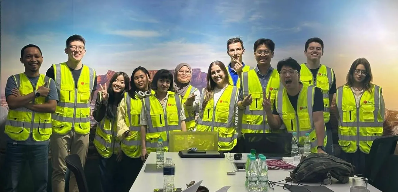 Belli and airline staff in high-visibility vests in a training room at a cargo terminal