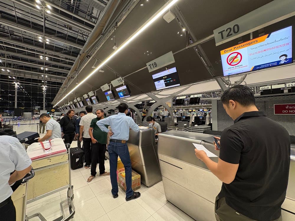 Passengers and cargo at the Bhutan Airlines check-in counters in Bangkok