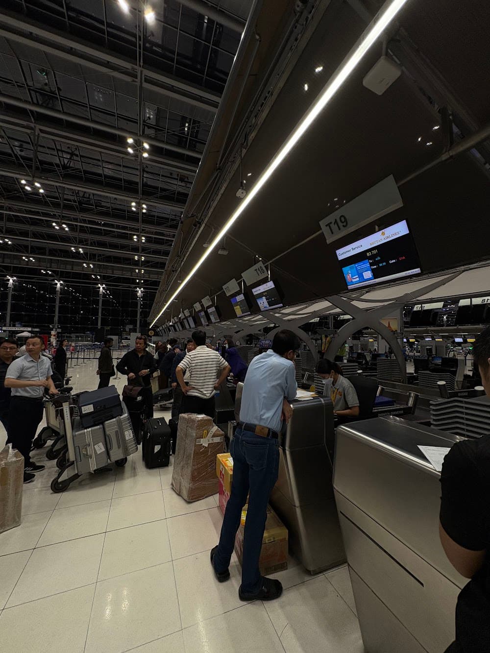 Boxed cargo waiting at the Bhutan Airlines check-in row in Bangkok