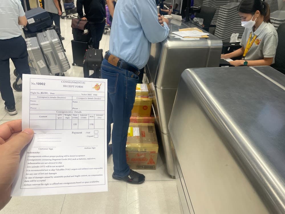 A paper Bhutan Airlines consignment receipt form, filled in by hand at the counter
