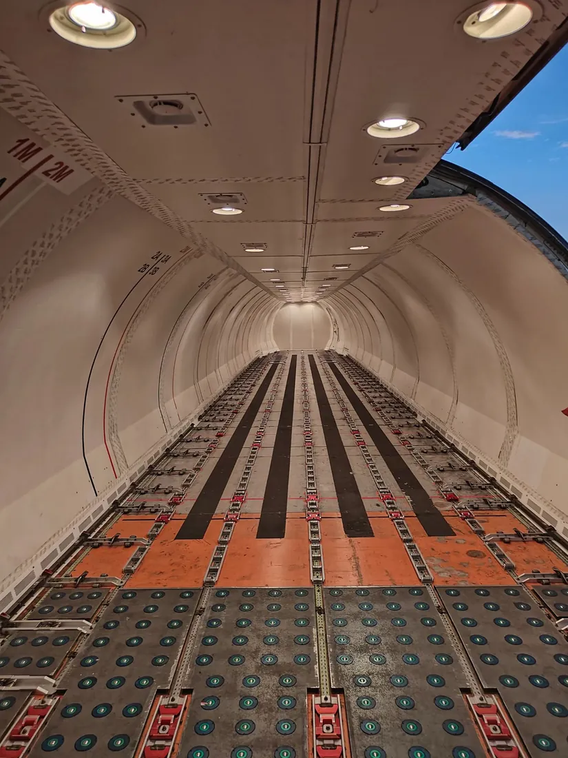 The empty main deck of a freighter, looking down the roller floor